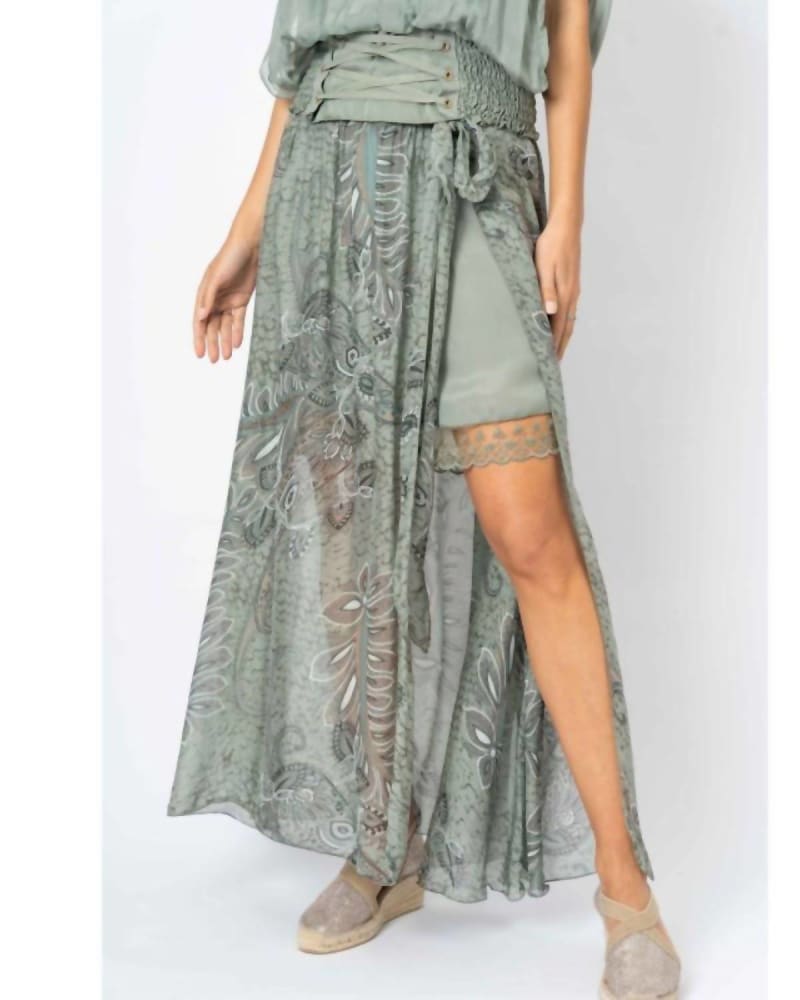 Front of a model wearing a size One Size Palm Leaf Print Long Skirt In Olive in Olive by Look Mode USA. | dia_product_style_image_id:359099